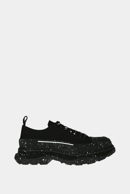 Black "Tread Slick" low top sneakers with white paint stains