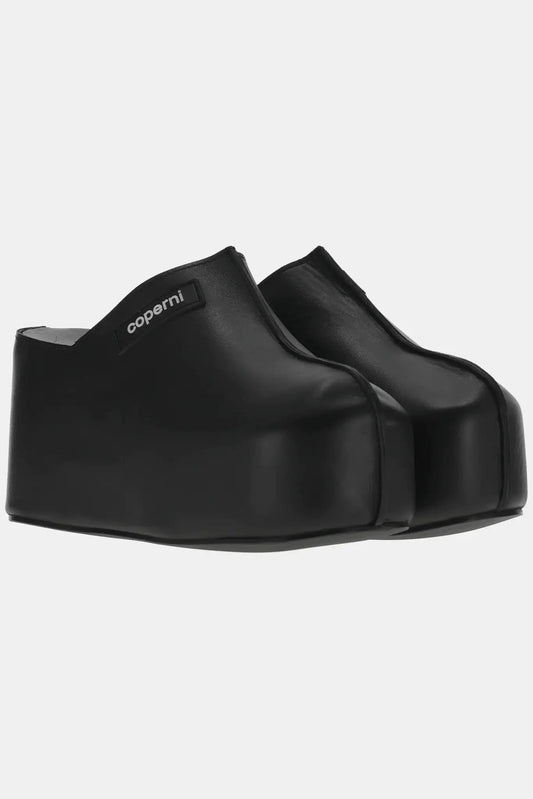 Coperni Black leather clogs with platform sole.