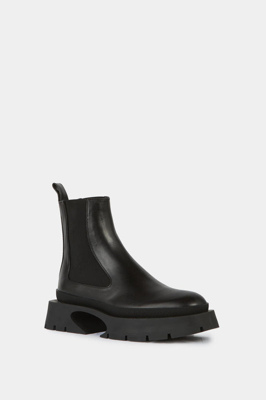Asymmetric sole ankle boots